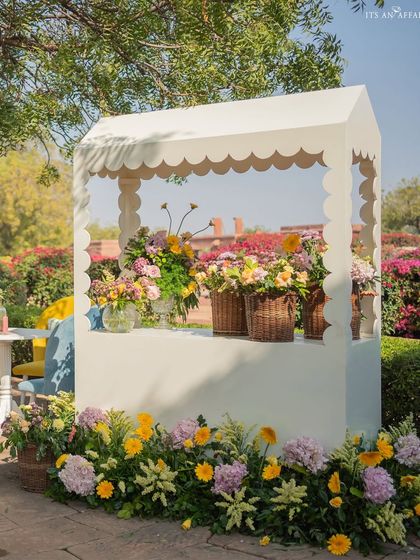 A flower cart filled with beautiful pastel blooms adds a touch of market-fresh charm to the elegant brunch.