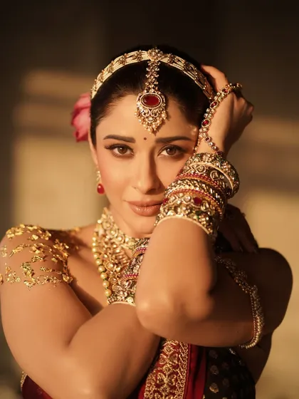 A stunning close-up of Nyra Banerjee, focusing on the expressive eyes and the intricate details of the headpiece and bangles. This shot highlights the precision of the makeup and jewelry styling.