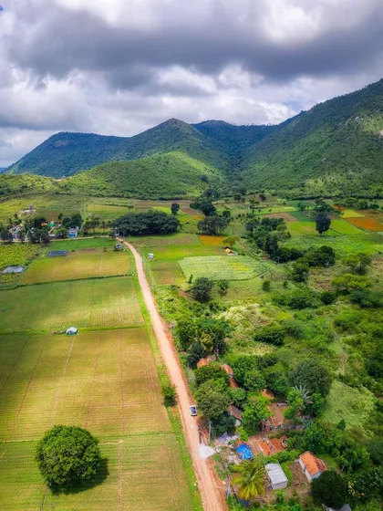 An aerial view of the vibrant green landscape at the foothills of Gopalaswamy Betta, part of the Bandipur National Park.