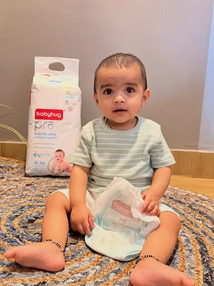 Another image from the Firstcry collaboration, this one shows Gauri holding an open Babyhug Pro diaper. This gives a clear view of the product's interior texture while reinforcing the happy baby imagery.