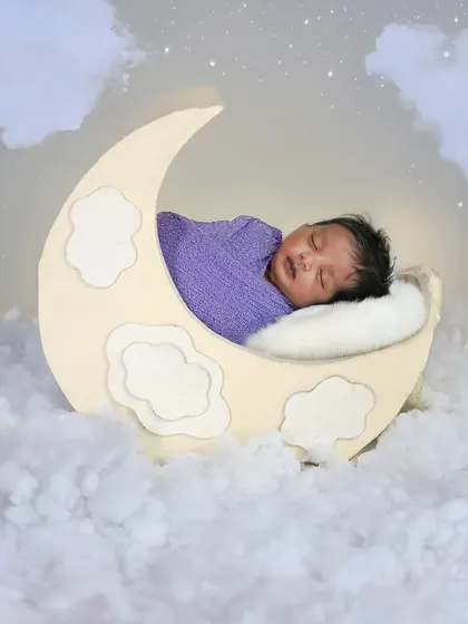I love getting creative with dreamy themes like this 'Baby on the Moon' setup. With soft clouds and twinkling stars, we can create a magical, peaceful portrait of your sleeping baby.