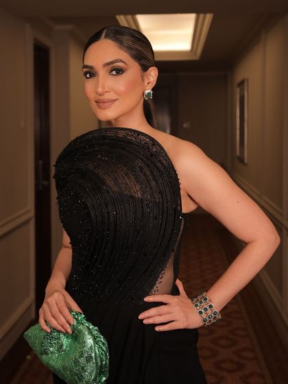 Another angle of the client, her green clutch adding a pop of color to the all-black ensemble.