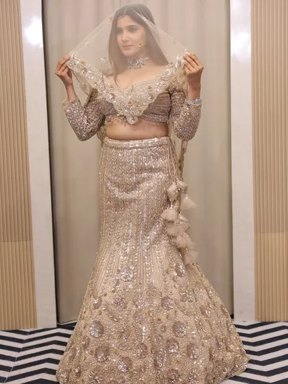 The versatility of our outfits is shown here with a sheer dupatta. You can style this sequin lehenga in multiple ways to suit the event.