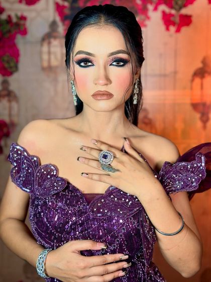 The complete look with the stunning purple gown. The makeup is powerful yet elegant, designed to complement the outfit.
