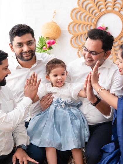 A family high-five. This photo captures a fun, interactive moment with the extended family, full of smiles and positive energy.