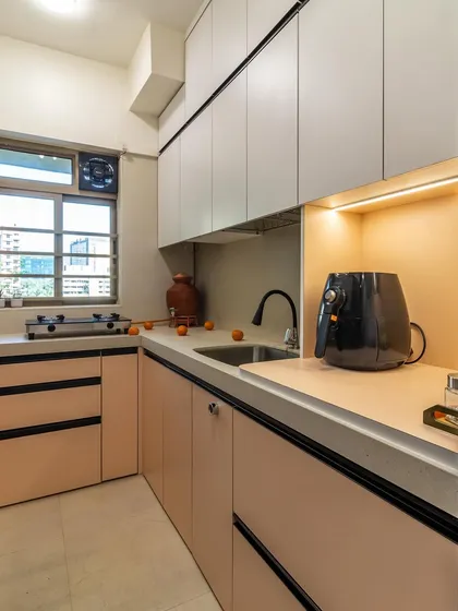 This is one of our most popular color combinations for a kitchen: soft peach and grey cabinets with black hardware for a touch of contrast.
