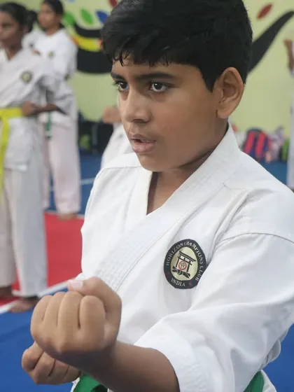 The look of pure focus. We teach our students that power comes not just from the body, but from a disciplined mind. This young warrior is practicing his basic stance and punch (Kihon).