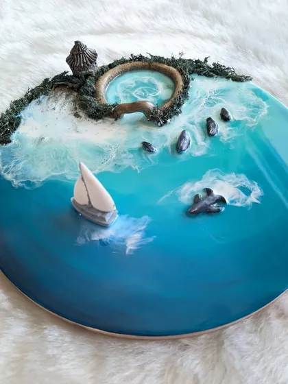 Bring the calm of the ocean into your home. This finished resin art piece, complete with a tiny sailboat and textured shoreline, is an example of what you can create. It’s a beautiful reminder that you don’t need experience to make something truly special.