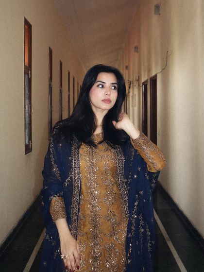 A closer, three-quarter shot of the Asim Jofa ethnic wear, allowing the viewer to see the detailed embroidery on the bodice and sleeves.