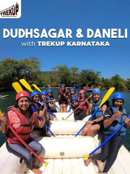 A happy group of women geared up with paddles and life jackets, ready for their river rafting adventure in Dandeli.