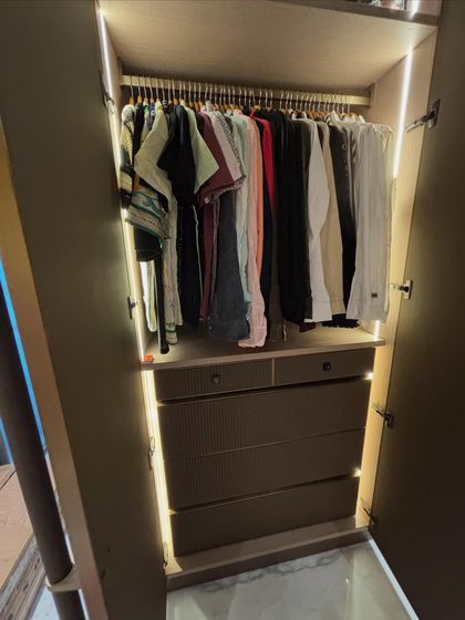 A full view of a transformed wardrobe. Notice the combination of hanging space for shirts and dresses, plus deep drawers below for folded items. I help you map out your wardrobe to make the best use of every single inch.