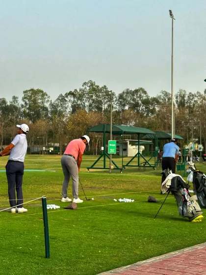A view from the side of the range, showing golfers practicing with the help of our portable canopies.