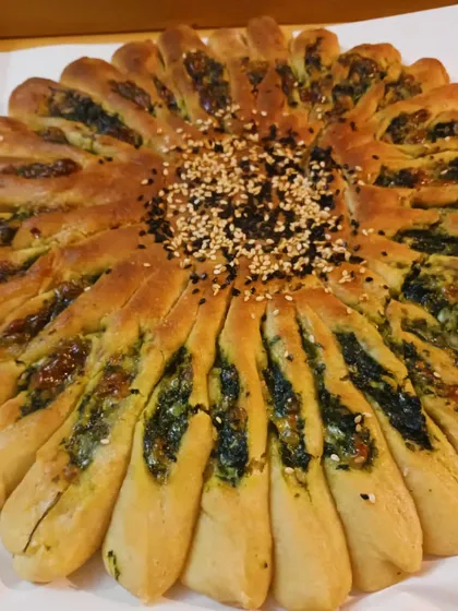 This beautiful Millet Sunflower Bread is one of my specialties. It's a gluten-free pull-apart bread, stuffed with a delicious filling of spinach and my homemade vegan cheese, then topped with sesame seeds.