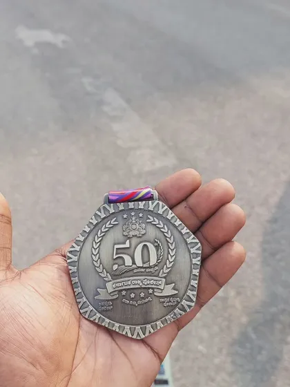 Holding the reward. A close up of the Golden Jubilee Run finisher medal.