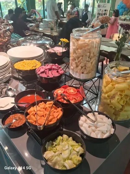 A close-up of our live pasta and salad bar at a corporate event. We offer a variety of fresh ingredients like assorted pasta, vegetables, and cheeses, allowing guests to create their own custom meal. It's a healthy and engaging option for office lunches.