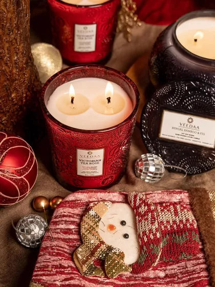 Christmas is a feeling. Our Victorian Tea Rose candle in a festive red jar, surrounded by holiday decor, captures the warmth and joy of the season.