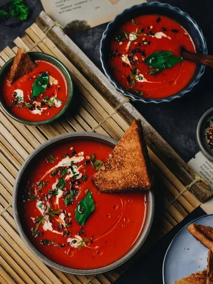 Soup season is here. A comforting bowl of warm tomato soup, styled with fresh basil and a grilled cheese crouton. The dark, moody lighting makes it feel extra cozy.