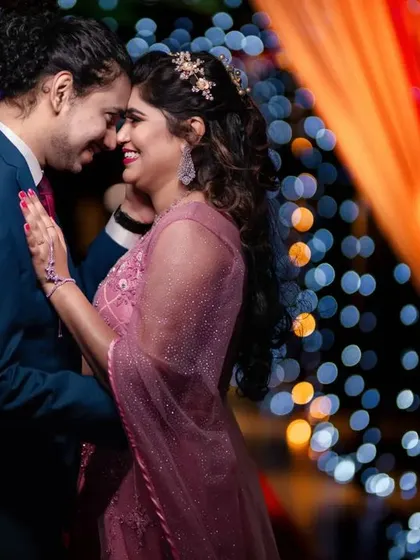 As the sun sets, the party begins. We specialize in reception photography, using creative lighting to capture the romance and energy, like this beautiful dance floor moment with a sparkling bokeh background.