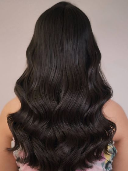 The back view of this beautiful dark brunette style, showcasing the healthy shine and long, flowing layers.