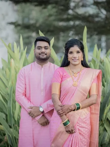 A classic portrait of the couple in matching pink outfits for their engagement shoot.