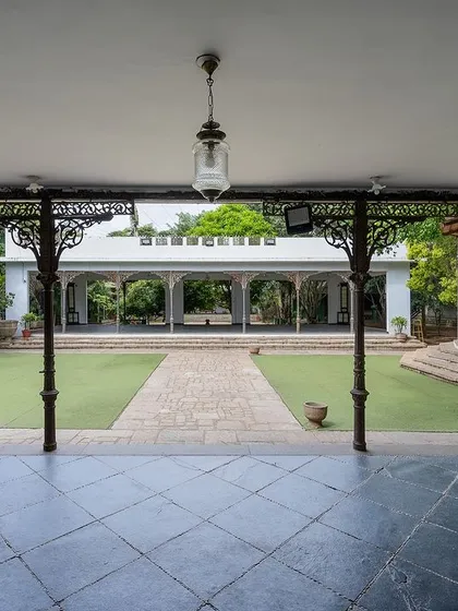 A view of the grand lawn and our colonial bandstand, framed by antique pillars. This open space is perfect for large ceremonies, offering a sense of scale and history.