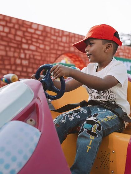 A young guest enjoys one of the many rides in the 'Adventureland' section of Sanay's party. I believe in creating zones with different types of fun for all ages.