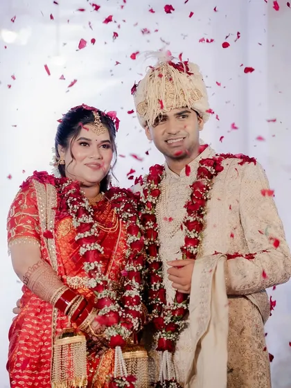 A happy portrait of the couple after the varmala ceremony, surrounded by love and blessings.