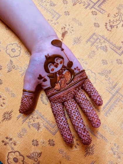 An adorable penguin design for a child, showing that mehendi can be fun for all ages.