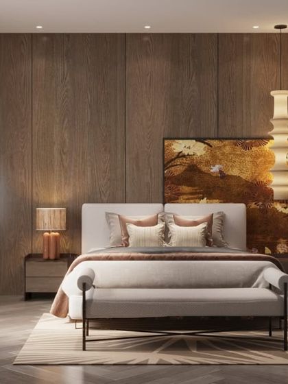 This bedroom is layered in warmth, from the wood-paneled backdrop to the earthy-toned textiles. The hero elements are the sculptural pendant light and an artful folding screen, which add quiet drama and depth to the space.