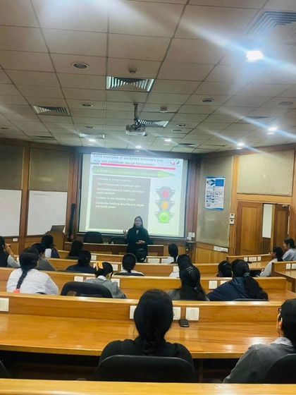 Conducting a POSH awareness session in a lecture hall setting. The traffic light analogy on the screen is a simple yet effective tool I use to explain the different levels of behavior.