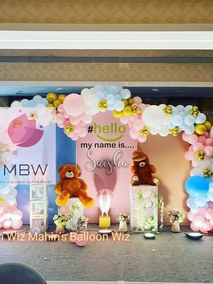 Another perspective of the sweet naming ceremony setup, highlighting the hot-air balloon props and the balanced color scheme.