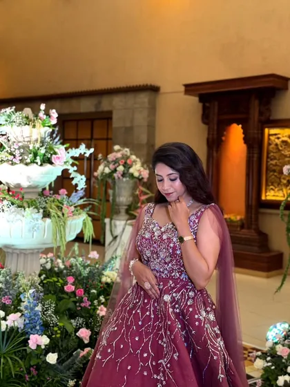 A gown that sparkles as much as your love. This wine-colored dress with silver embroidery is an elegant and romantic choice for an engagement party.