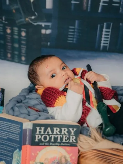 Chewing on his wand, this little wizard is exploring his new magical powers.