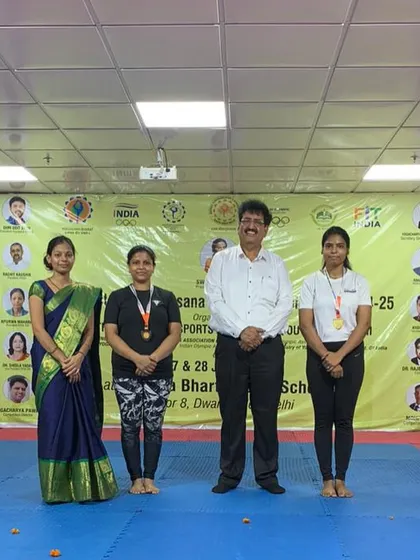 My students Preeti (gold) and Shabana (bronze) with their medals at the 4th District Level Yogasana Sports Championship.