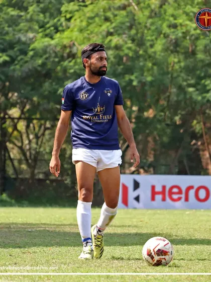 A senior player from my academy scans the field during an A Division match, demonstrating the composure and vision of an experienced player.