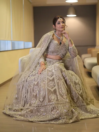 A full-length shot showcasing the entire ensemble. The makeup complements the heavily embellished outfit without overpowering it, a key principle of balanced styling.
