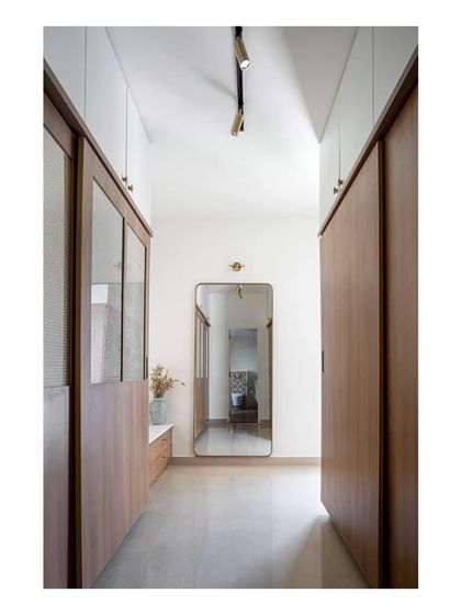 Another view of the guest room's walk-in closet, featuring sliding doors and a full-length mirror to enhance the sense of space.
