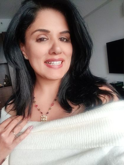 A close-up of the off-shoulder pullover and the polki necklace. The Bardot-style neckline is perfect for showcasing a beautiful statement neckpiece.