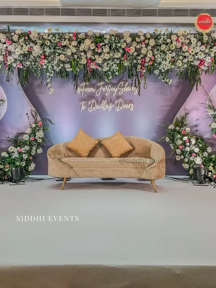 We brought this couple's long-distance love story to life with a personalized neon sign and a modern, elegant stage design, blending soft lavender with lush florals for their engagement.