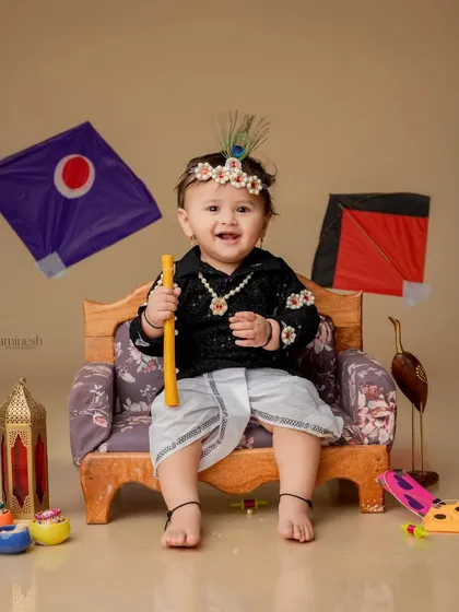 A bright smile captured during the Makar Sankranti festival session. The baby girl is holding a yellow firki, perfectly matching the joyful mood of the photo.
