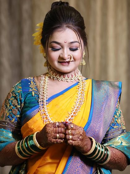 A moment of quiet reflection for the bride. This shot beautifully captures the soft, blended eyeshadow and the perfectly shaped brows that frame her face.