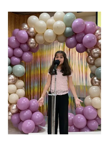 This student's expressive performance during the comedy showcase was a highlight of the evening.