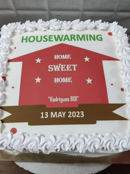 A housewarming cake to celebrate a new home. This custom photo cake features a "Home Sweet Home" design with the family's address.