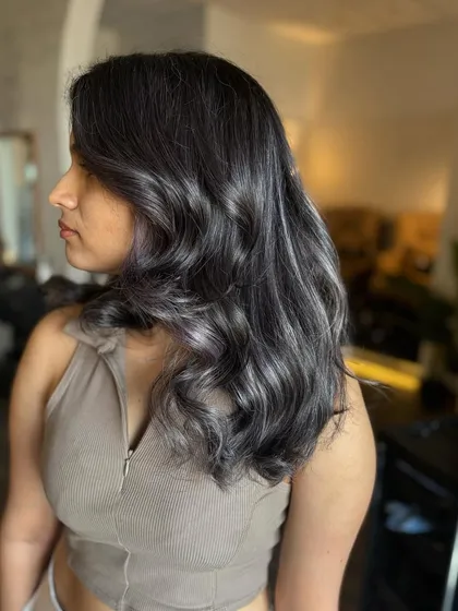 A side profile of the Ash Lilac look, highlighting the soft waves and the beautiful blend of grey and purple.