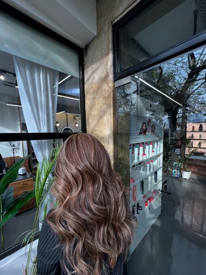 This shot captures the beautiful blend of colors and the healthy shine of the hair, achieved with professional products and techniques.