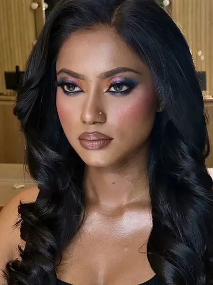 The rich pigments of the eyeshadow pop beautifully against her melanin-rich skin, creating a stunning contrast.