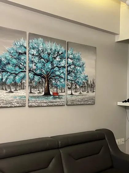 The blue tree canvas art installed in a client's home, perfectly matching their modern decor.