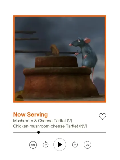 The second course is served. This graphic shows that as Remy cooks with mushrooms on screen, our guests are served a delicious Mushroom & Cheese Tartlet, available in both veg and non-veg versions.