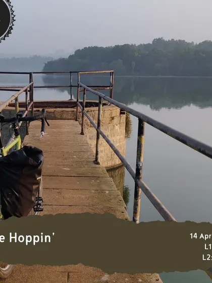 A bike with panniers rests on a jetty during our 'Lake Hoppin'' tour, showing that even our shorter rides can feel like a grand adventure.