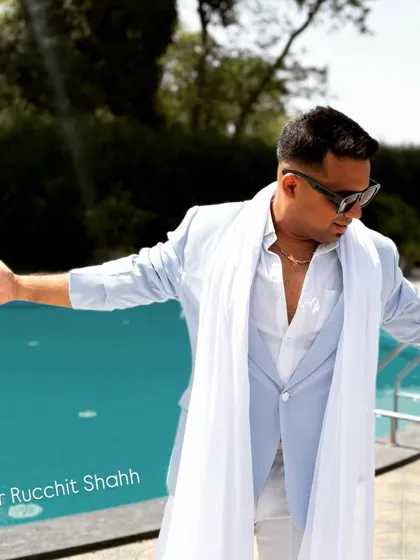 With open arms, ready to embrace the energy of the crowd. This pose, taken by the pool, shows my approachable and charismatic personality.